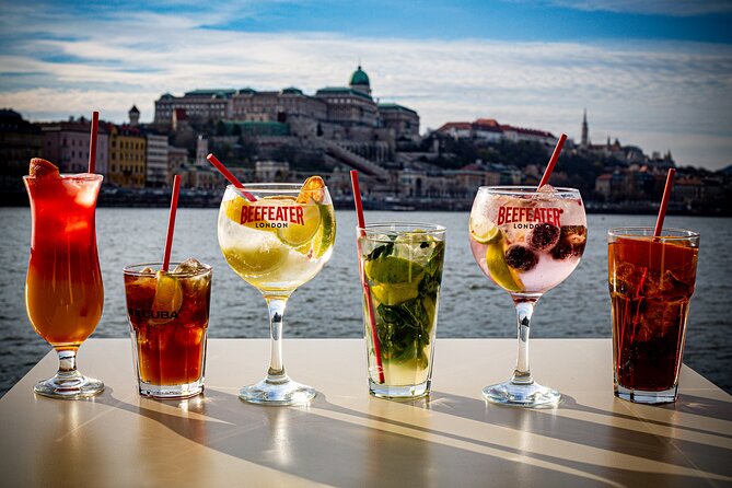 Cocktail Cruise and City Views on the Danube in Budapest - Two cocktails, a menu, and table service